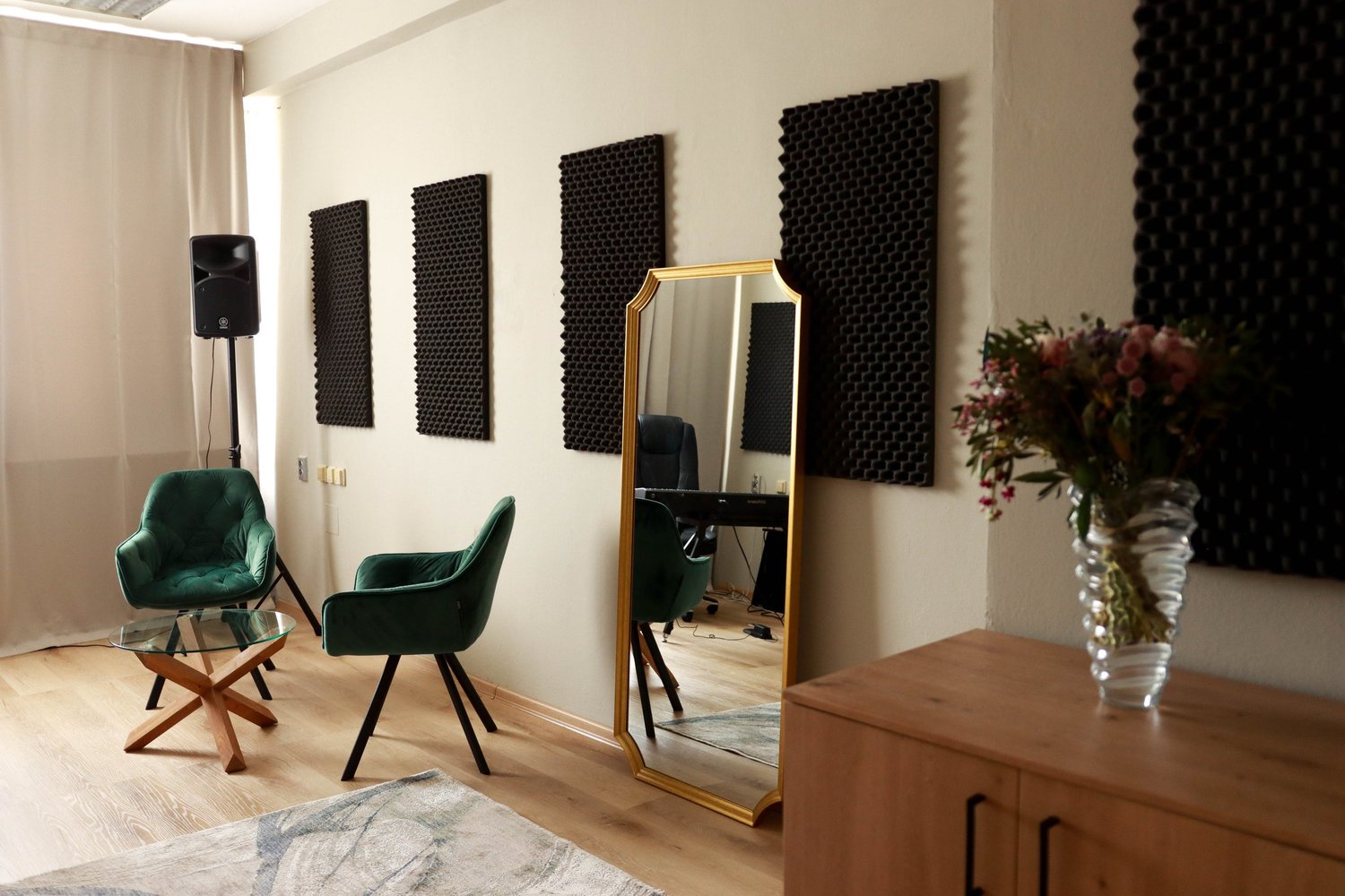 Green armchairs, mirror and acoustic panels in the Singasong studio
