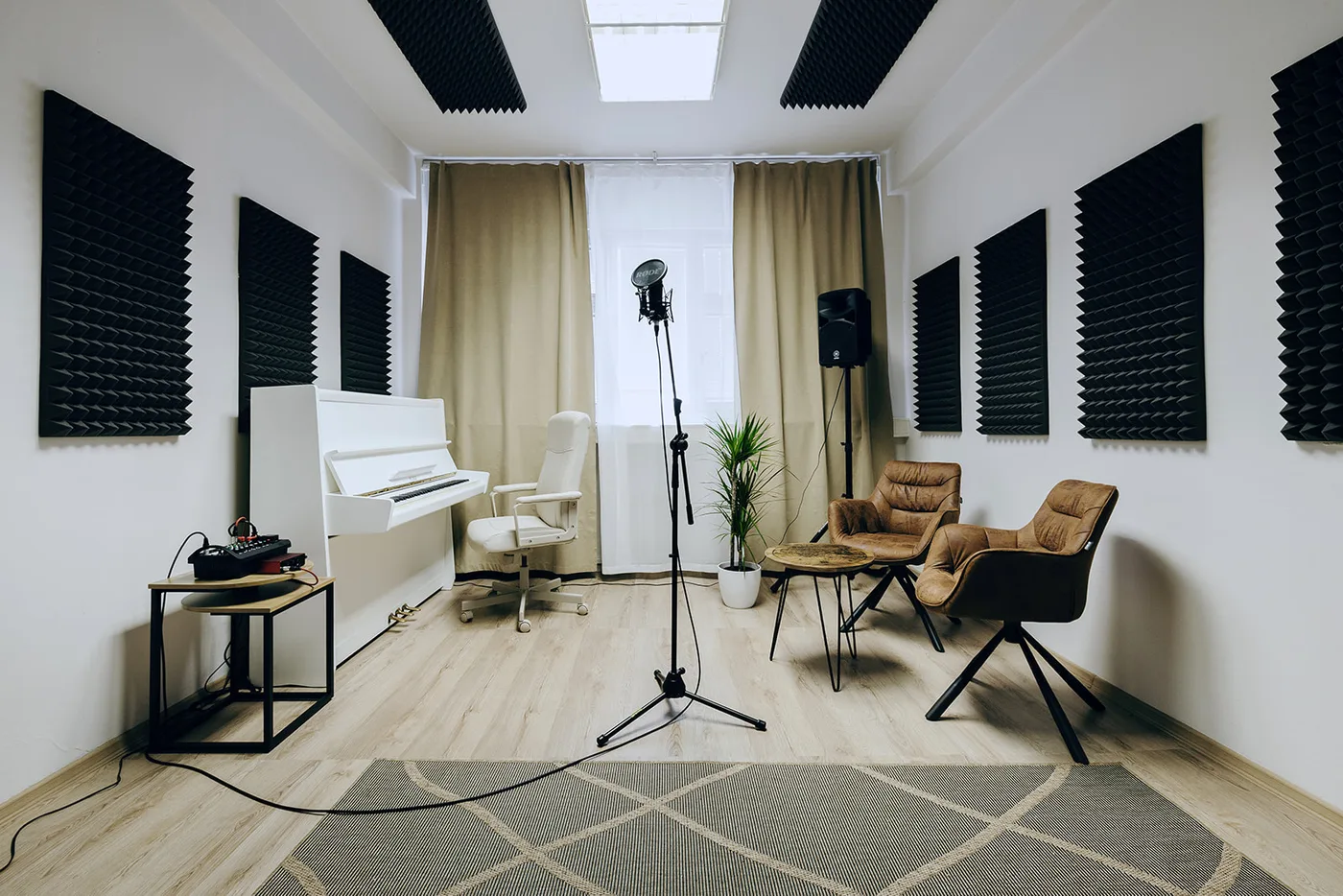Bright Singasong studio with a piano and microphone
