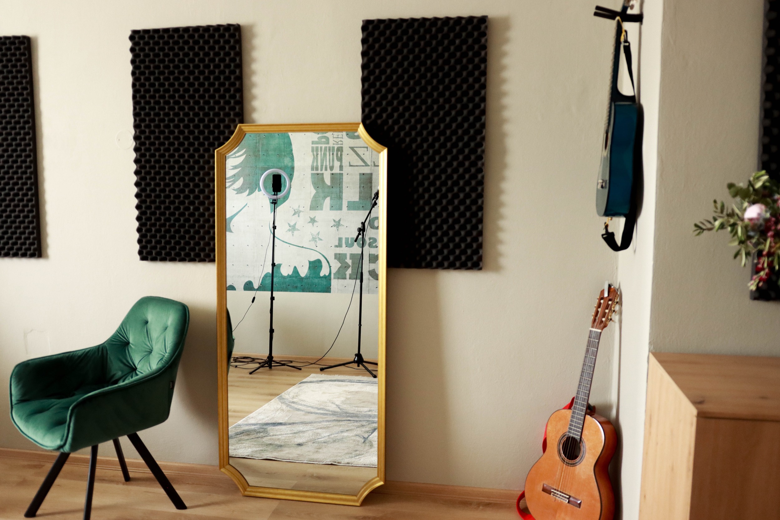 Second Singasong studio with a mirror, guitar and green armchair